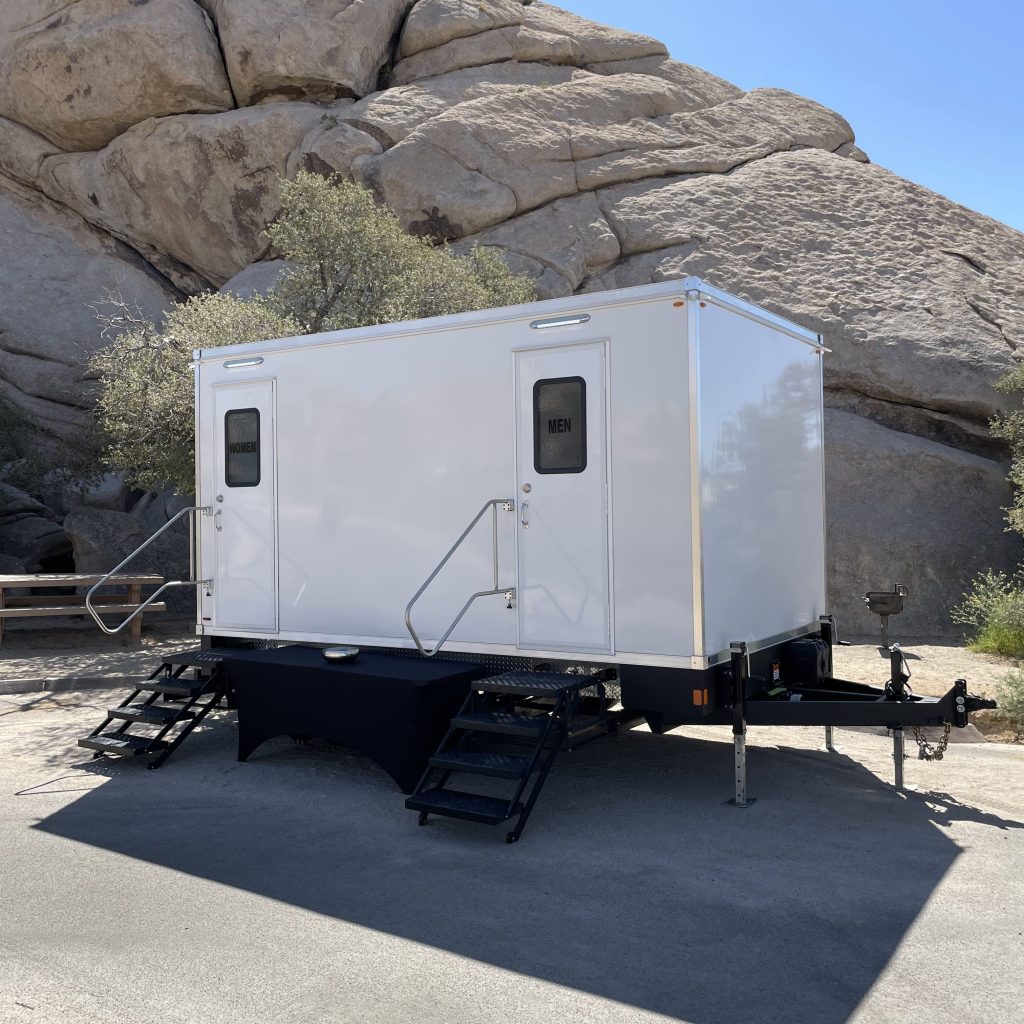 Exterior view of the VIP Rentals, LLC 5-station luxury restroom trailer at an event in Joshua Tree, CA
