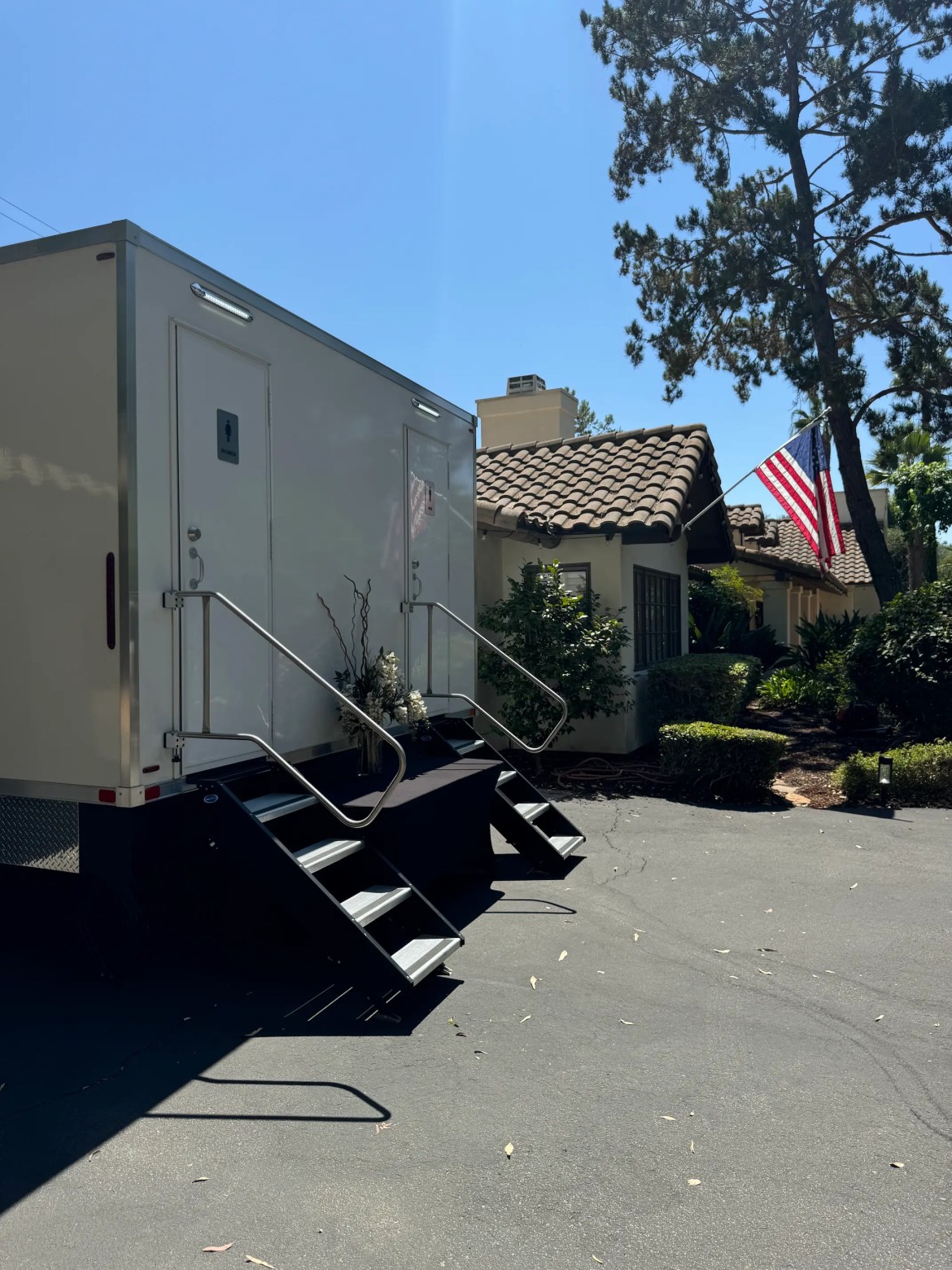 Backyard Wedding Poway 1 VIP Rentals, LLC luxury restroom trailer parked at a backyard event in Southern California with an American flag in the background