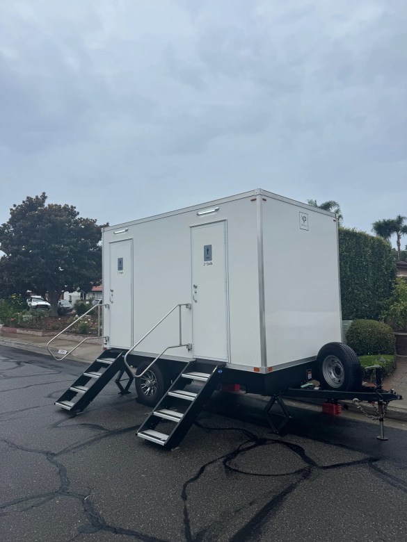 VIP Rentals, LLC 4-station bathroom trailer at a block party in San Juan Capistrano on a cloudy day.